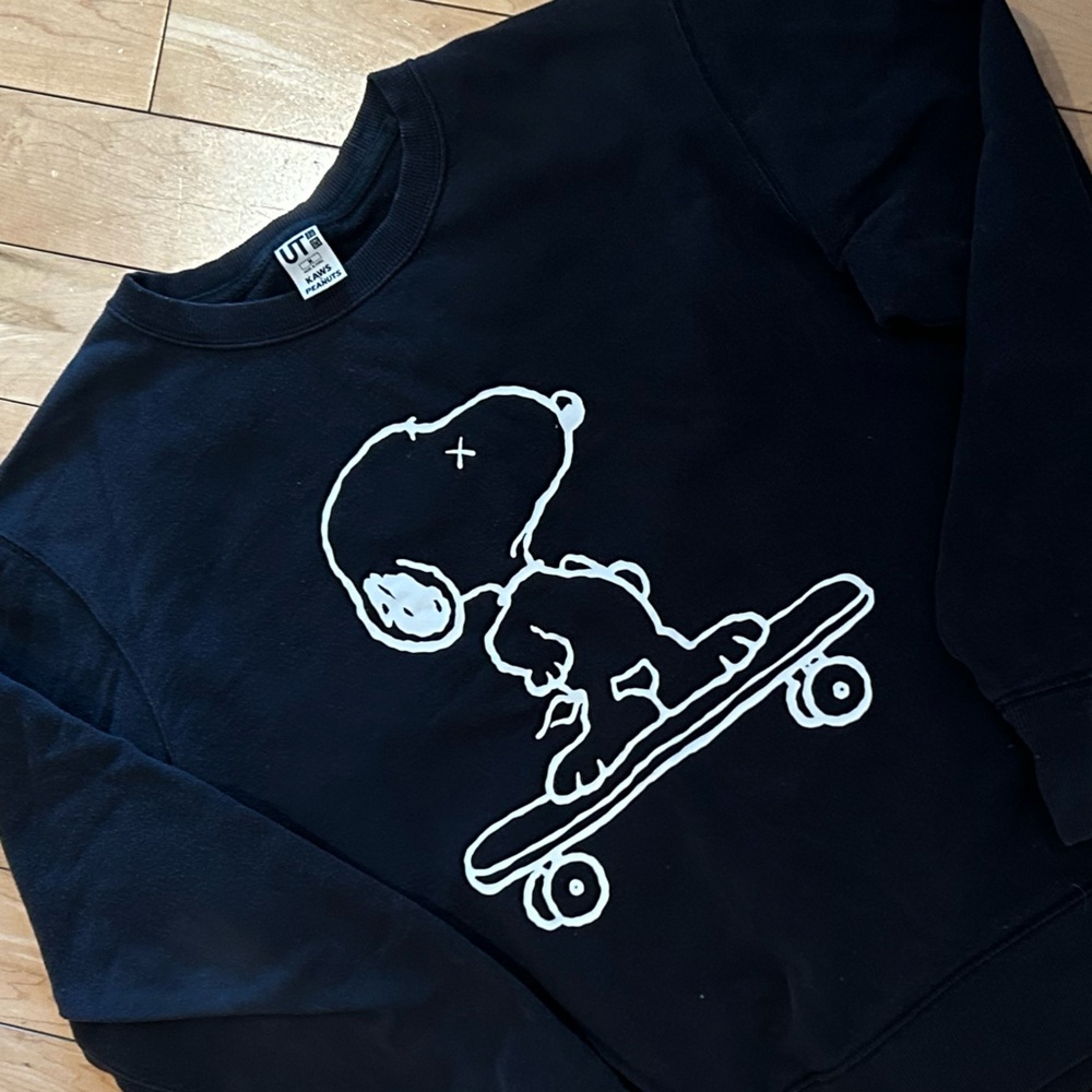 Uniqlo x KAWS Black Crewneck Sweatshirt with White Snoopy Skateboard Graphic